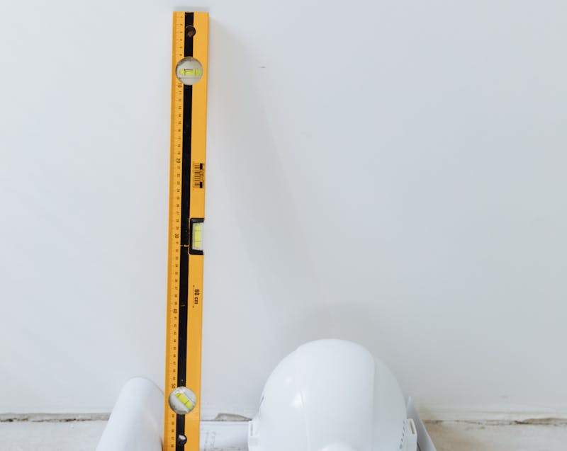 a level bar and a hard hat